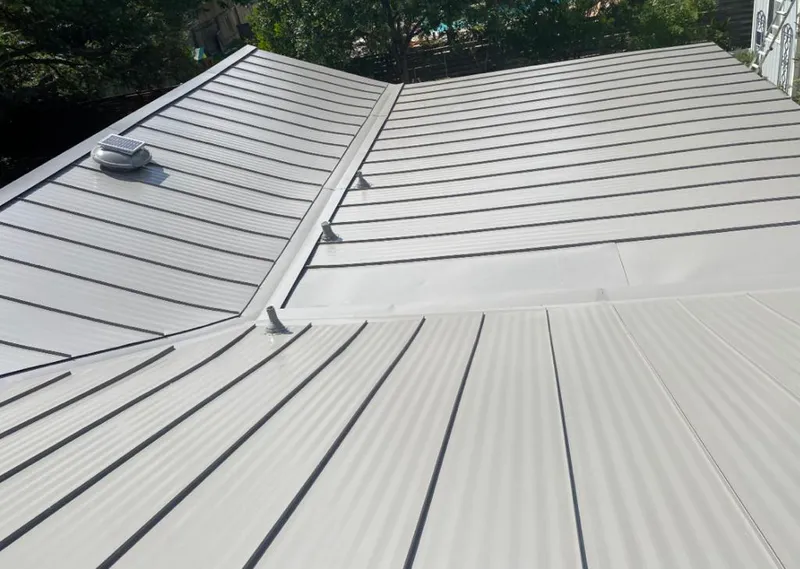 Solar attic fan installed on a metal roof for Roof Ventilation in Valparaiso